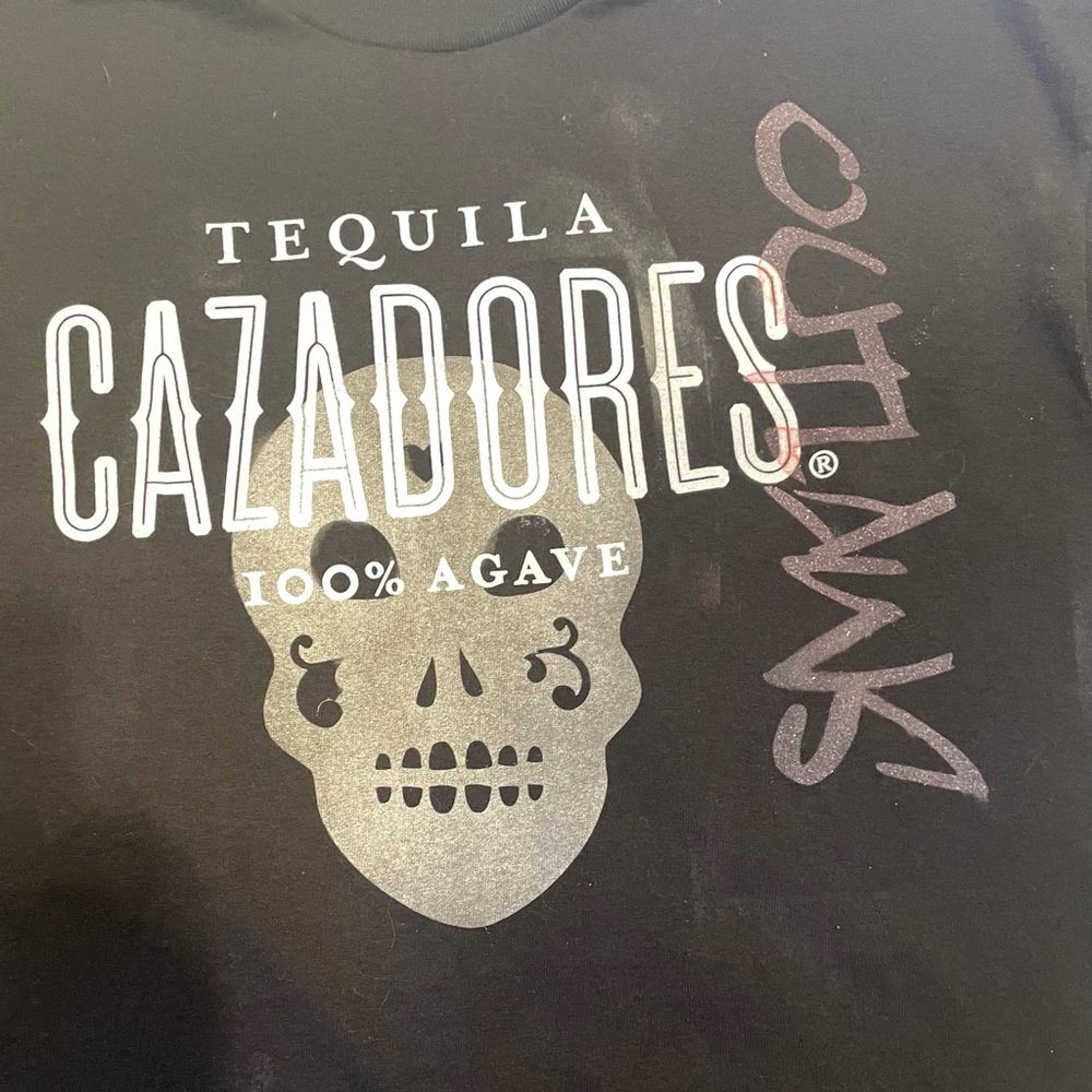 Stand out in our black tee featuring bold sugar skulls. Comfy and stylish